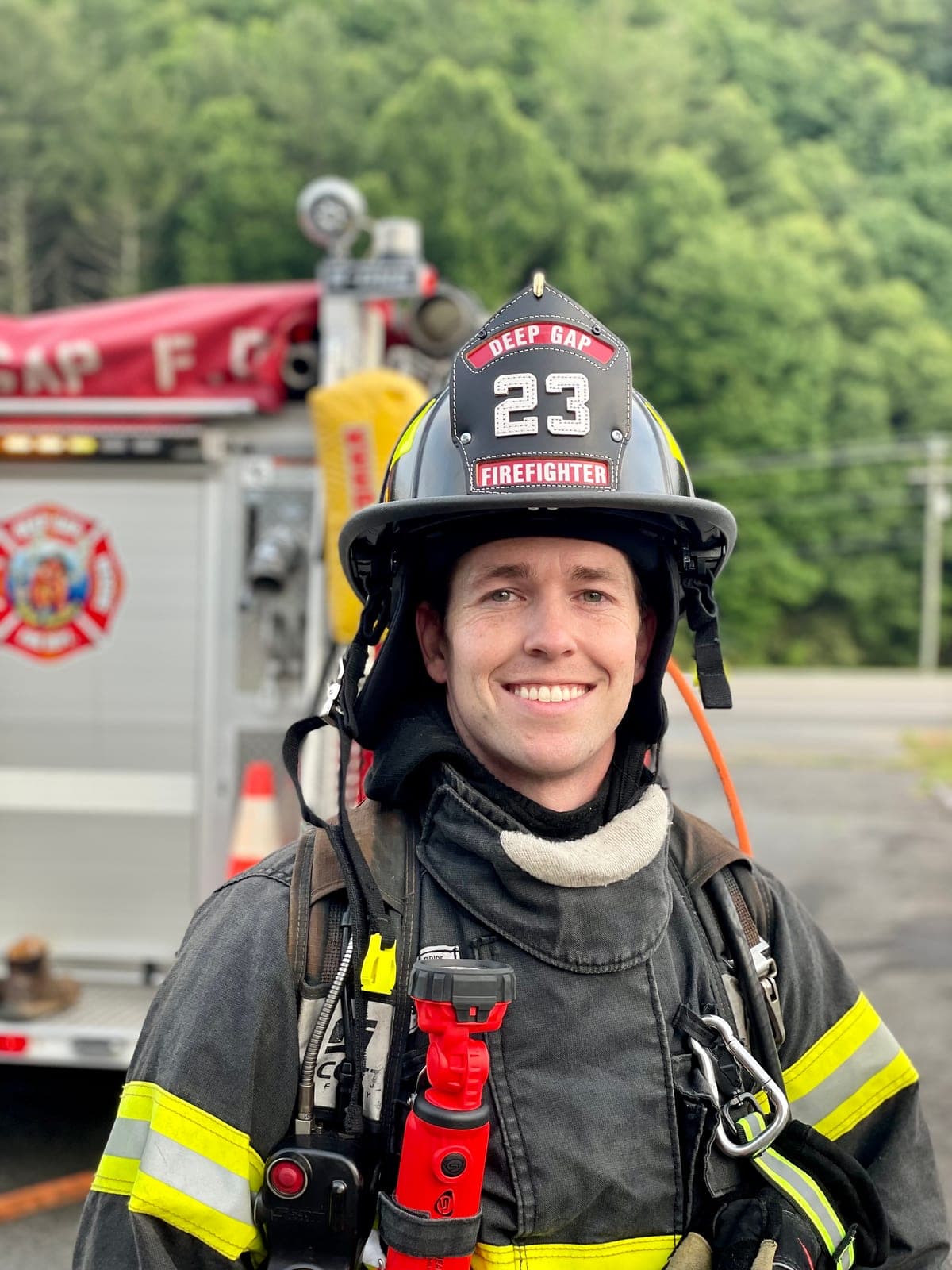 David in turnout gear beside a Deep Gap Volunteer Fire Department engine